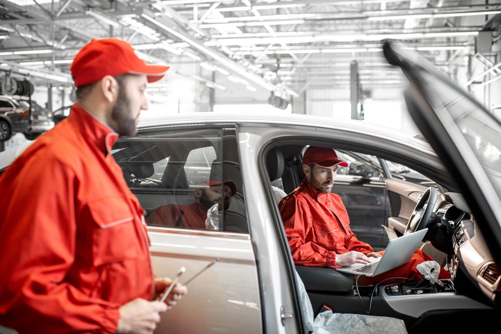 auto-mechanics-diagnosing-car-with-computer-2025-03-15-17-04-00-utc